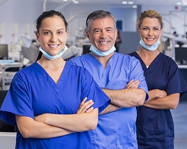 Three dentists in scrubs at a training session